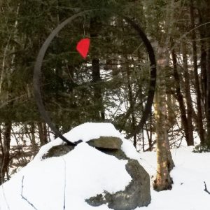 snow on a rock with red heart